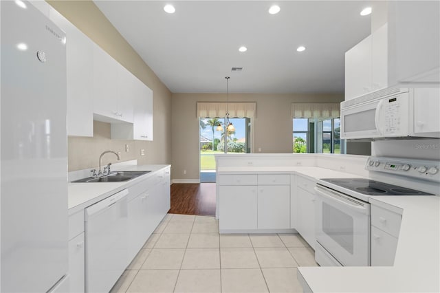 kitchen with light tile patterned flooring, sink, pendant lighting, white appliances, and white cabinets