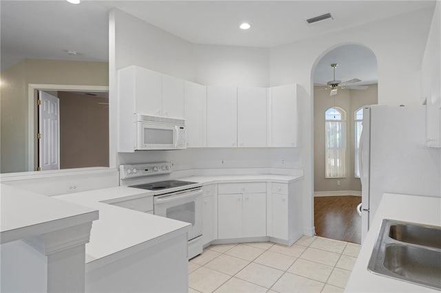 kitchen with white cabinetry, light tile patterned floors, ceiling fan, and white appliances