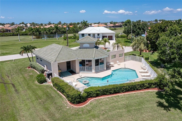 back of property with cooling unit, a fenced in pool, a patio, and a water view