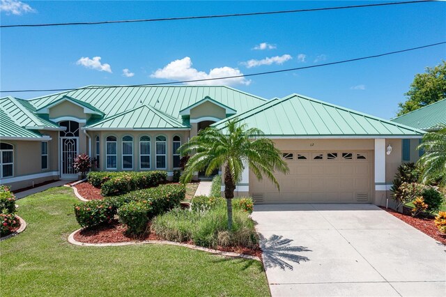 view of front of property featuring a garage and a front lawn