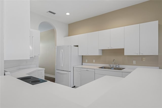 kitchen featuring white cabinetry, white appliances, and sink