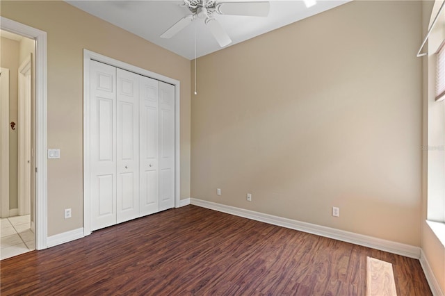 unfurnished bedroom with hardwood / wood-style flooring, a closet, and ceiling fan