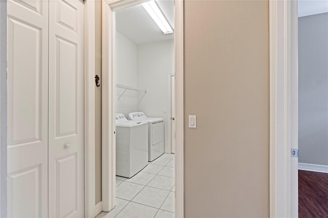 laundry area featuring washer and clothes dryer and light tile patterned floors