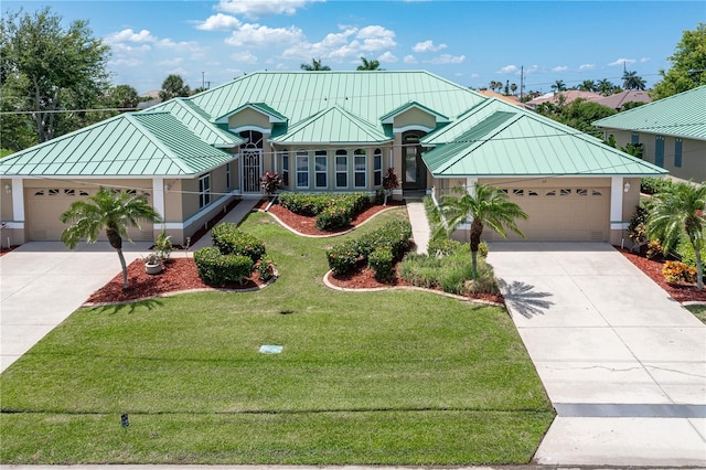 view of front of property featuring a garage and a front yard