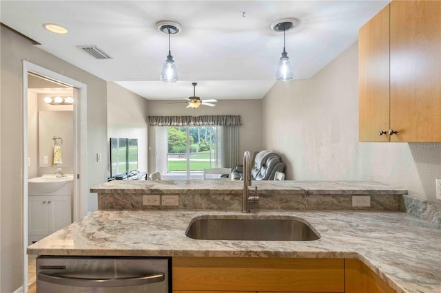 kitchen with light stone counters, visible vents, hanging light fixtures, stainless steel dishwasher, and a sink