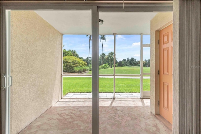 doorway to outside with a textured wall