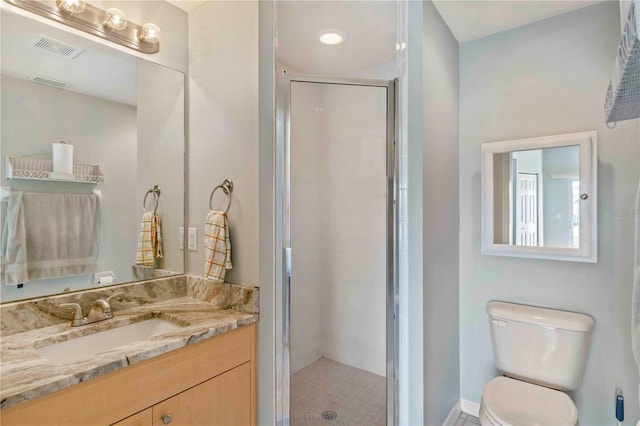 bathroom with vanity, toilet, and an enclosed shower