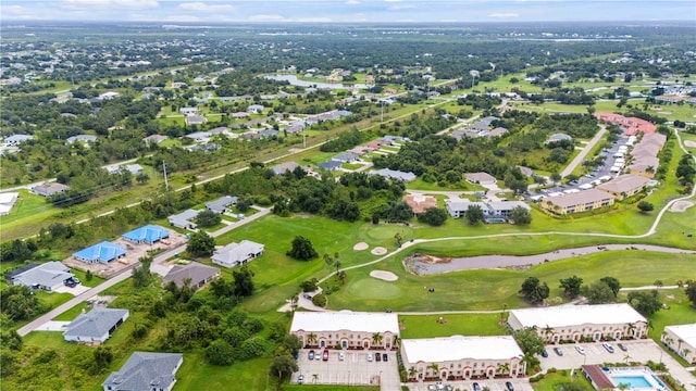 drone / aerial view featuring view of golf course and a residential view