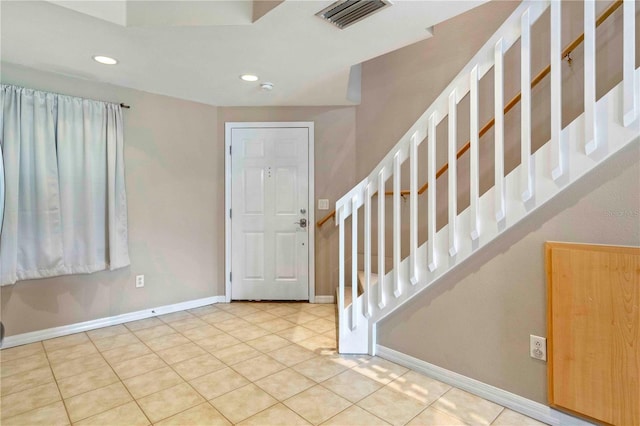 foyer entrance featuring baseboards, visible vents, stairway, tile patterned flooring, and recessed lighting