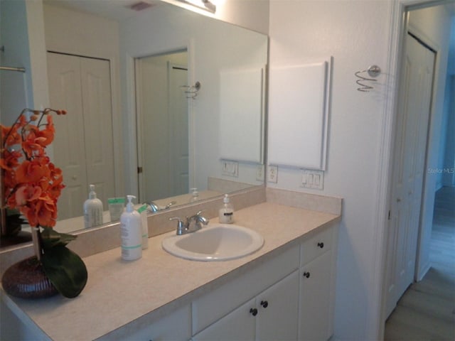 bathroom featuring vanity and wood-type flooring