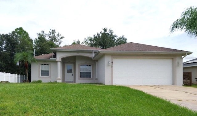 view of front of home with a front lawn and a garage