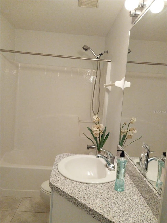 full bathroom featuring vanity, tile patterned floors, toilet, and tub / shower combination