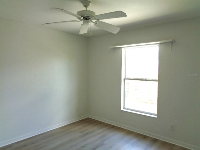 spare room with light hardwood / wood-style flooring and ceiling fan