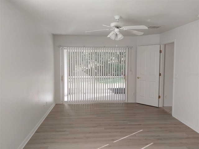 empty room featuring ceiling fan and light wood-type flooring