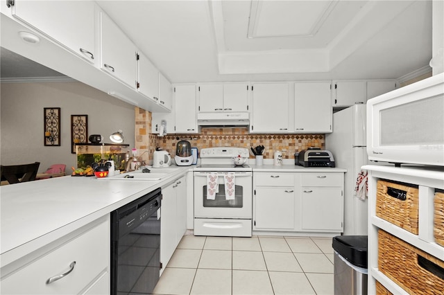 kitchen featuring light tile patterned flooring, white appliances, white cabinets, a tray ceiling, and decorative backsplash