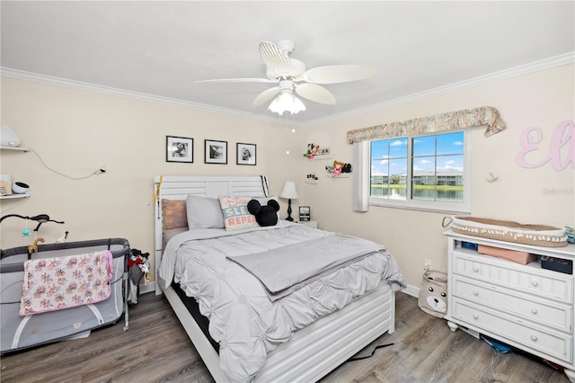 bedroom featuring ceiling fan, hardwood / wood-style flooring, and ornamental molding