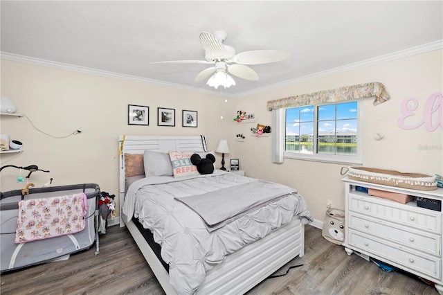 bedroom featuring ceiling fan, ornamental molding, and wood-type flooring