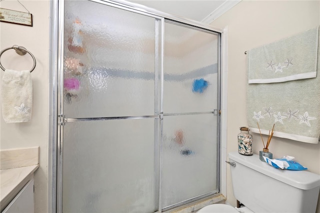 bathroom with walk in shower, toilet, vanity, and ornamental molding