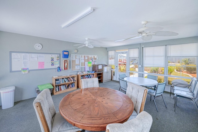 carpeted dining room with ceiling fan