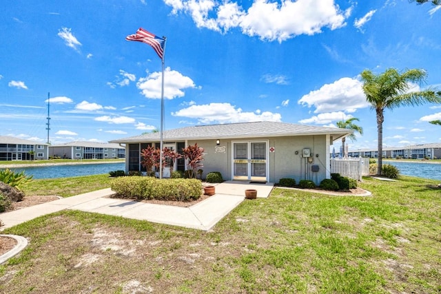 exterior space with a water view and a lawn