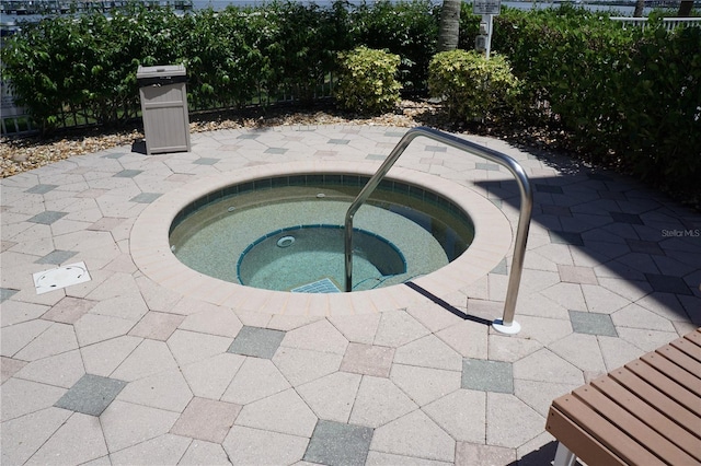 view of pool featuring an in ground hot tub and a patio area