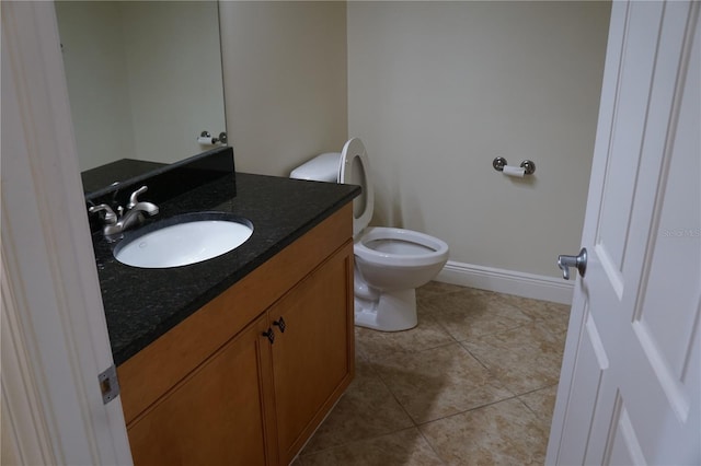 bathroom featuring tile patterned flooring, vanity, and toilet