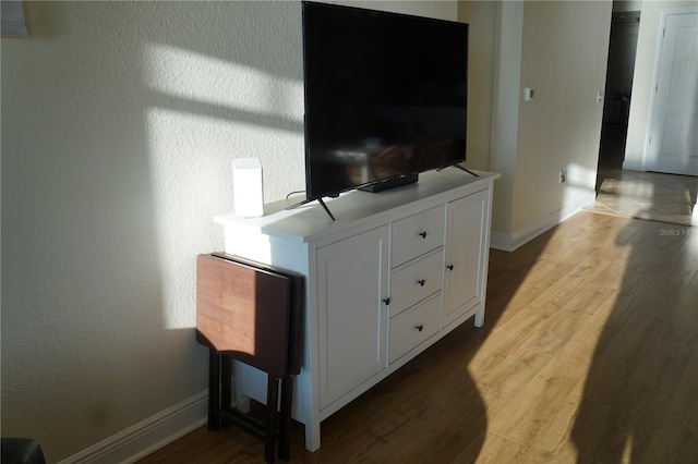 room details with baseboards and wood finished floors