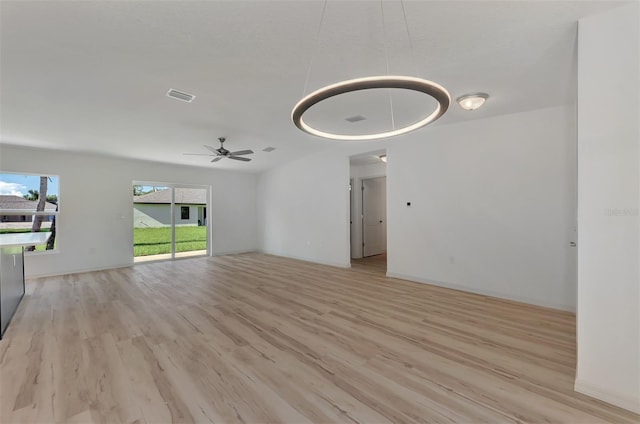 unfurnished living room with ceiling fan and light hardwood / wood-style floors