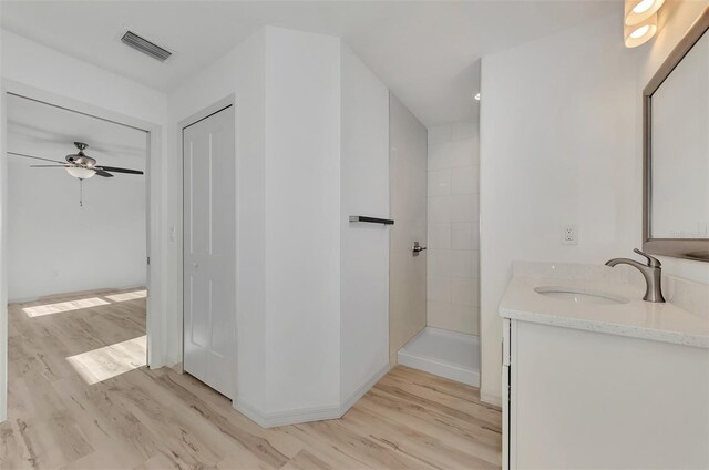 bathroom with vanity, ceiling fan, and hardwood / wood-style floors