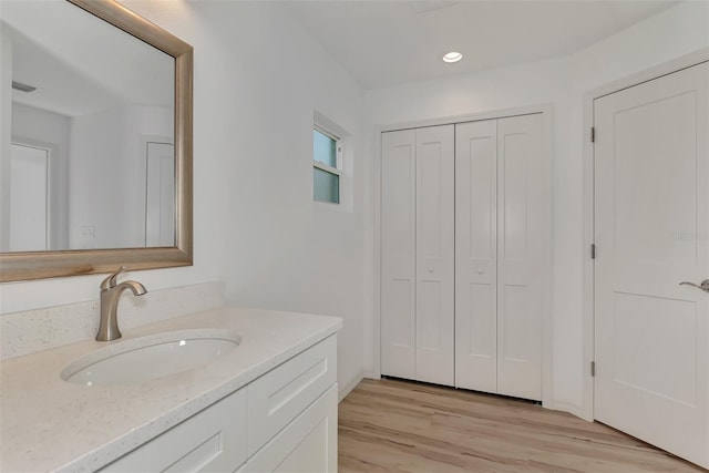 bathroom with hardwood / wood-style floors and vanity