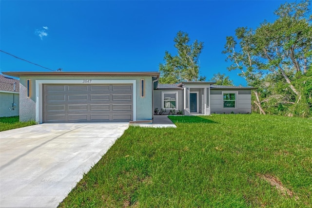 single story home featuring a front lawn and a garage