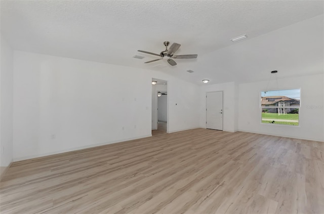 empty room with a textured ceiling, ceiling fan, and light hardwood / wood-style flooring