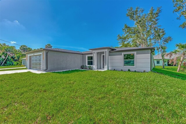 view of front of property with a garage and a front lawn