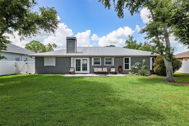 back of property featuring a patio area and a lawn