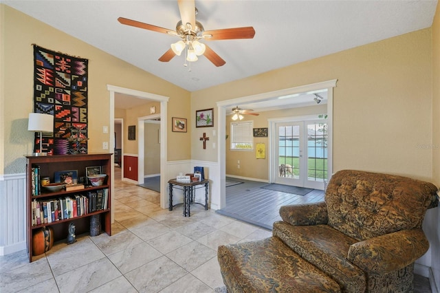 living area featuring ceiling fan, french doors, and vaulted ceiling