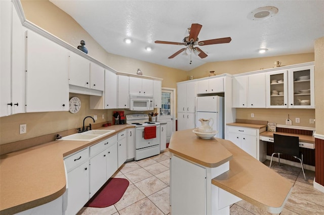 kitchen with vaulted ceiling, white cabinetry, a breakfast bar, and white appliances