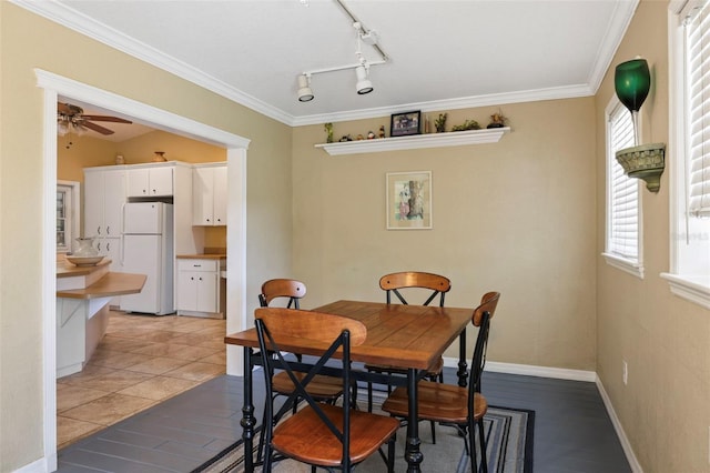 dining area with ceiling fan, light tile patterned floors, and crown molding