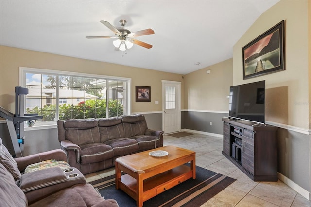 tiled living room featuring ceiling fan and lofted ceiling