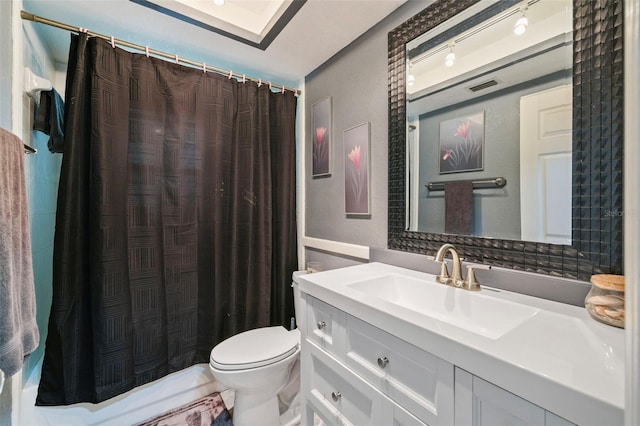 bathroom with toilet and vanity