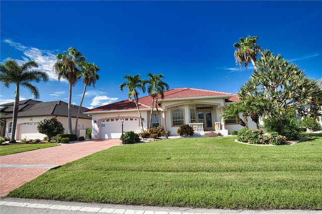 mediterranean / spanish home with a garage and a front yard