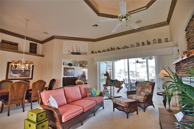 living room with ceiling fan with notable chandelier, light carpet, and crown molding