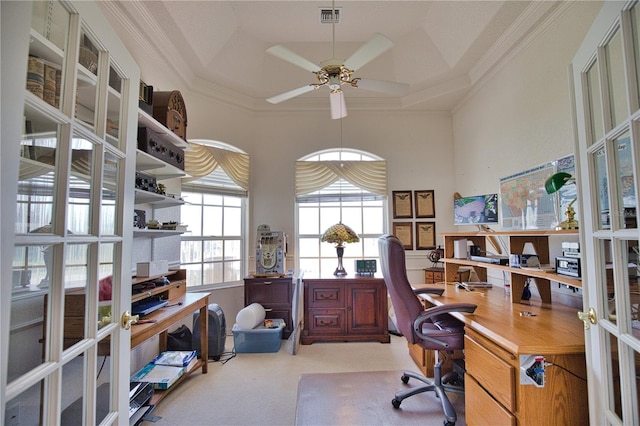 carpeted office with french doors, a raised ceiling, ceiling fan, and crown molding