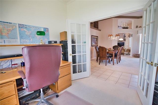 office area with french doors, a high ceiling, light tile patterned floors, and crown molding