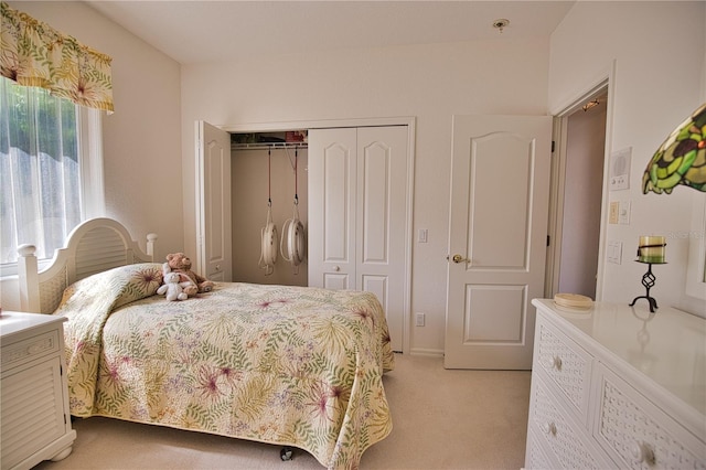 bedroom featuring a closet and light carpet