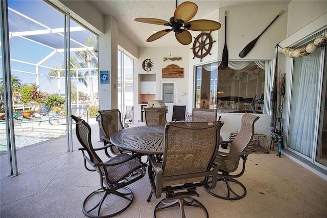 sunroom / solarium featuring ceiling fan