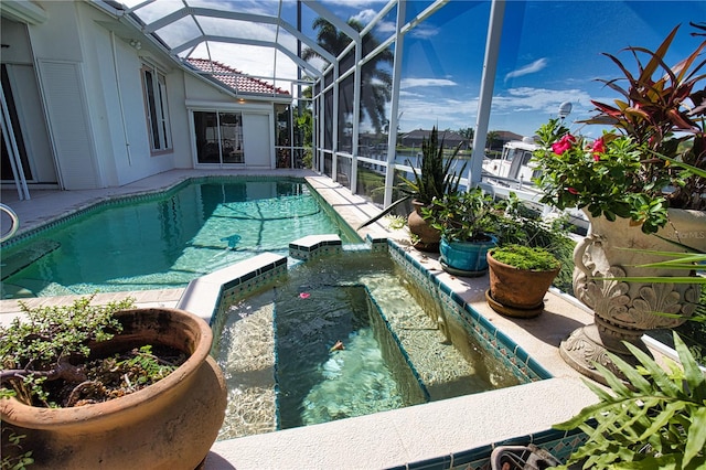 view of pool featuring glass enclosure