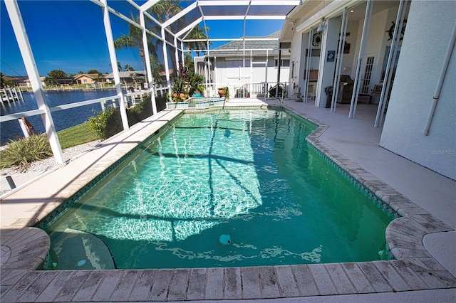 view of pool featuring an in ground hot tub, glass enclosure, and a patio area