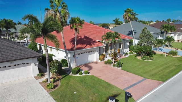 view of front of property with a garage and a front lawn