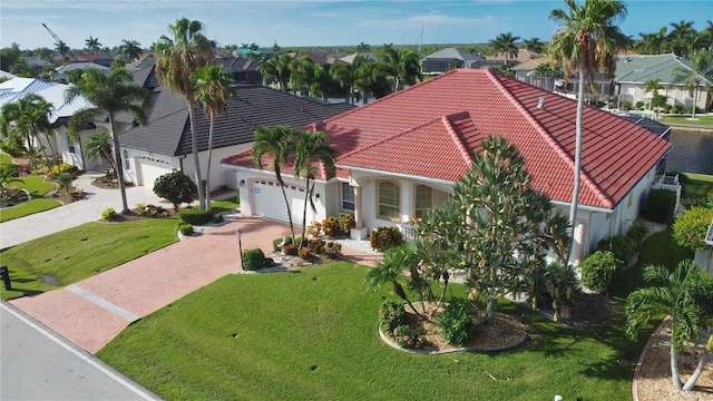 view of front of property featuring a garage and a front yard