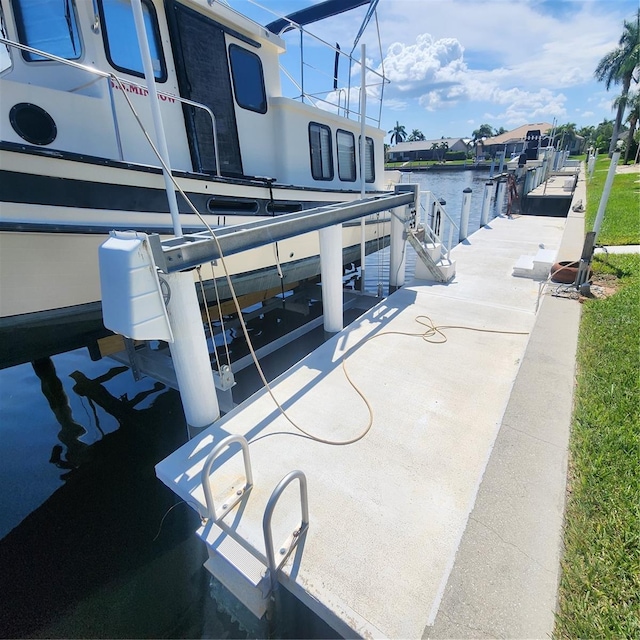 view of patio featuring a water view and a dock